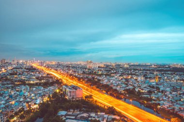 Aerial view of Bitexco Tower, buildings, roads, Vo Van Kiet road in Ho Chi Minh city - Far away is Landmark 81 skyscraper. Travel concept.