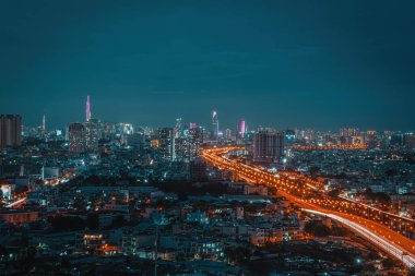 Aerial view of Bitexco Tower, buildings, roads, Vo Van Kiet road in Ho Chi Minh city - Far away is Landmark 81 skyscraper. Travel concept.
