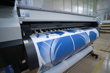 Ba Ria, VIETNAM - OCT 20, 2022 : Interior factory Large printing machine for paper business in printing room. Sublimation concept.