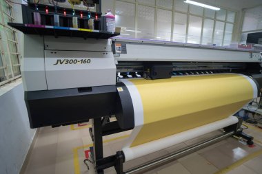 Ba Ria, VIETNAM - OCT 20, 2022 : Interior factory Large printing machine for paper business in printing room. Sublimation concept.