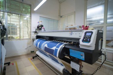 Ba Ria, VIETNAM - OCT 20, 2022 : Interior factory Large printing machine for paper business in printing room. Sublimation concept.
