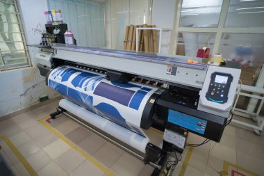 Ba Ria, VIETNAM - OCT 20, 2022 : Interior factory Large printing machine for paper business in printing room. Sublimation concept.
