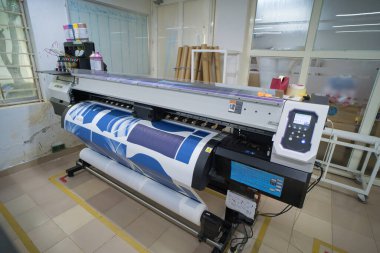 Ba Ria, VIETNAM - OCT 20, 2022 : Interior factory Large printing machine for paper business in printing room. Sublimation concept.