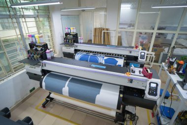 Ba Ria, VIETNAM - OCT 20, 2022 : Interior factory Large printing machine for paper business in printing room. Sublimation concept.