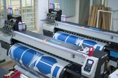 Ba Ria, VIETNAM - OCT 20, 2022 : Interior factory Large printing machine for paper business in printing room. Sublimation concept.