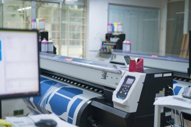 Ba Ria, VIETNAM - OCT 20, 2022 : Interior factory Large printing machine for paper business in printing room. Sublimation concept.