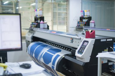 Ba Ria, VIETNAM - OCT 20, 2022 : Interior factory Large printing machine for paper business in printing room. Sublimation concept.