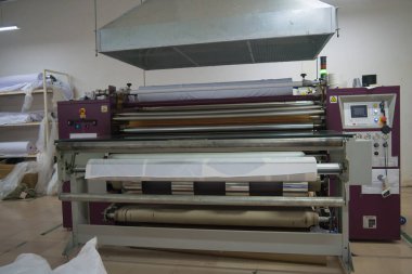 Ba Ria, VIETNAM - OCT 20, 2022 : Interior factory Large heat press machine for fabric business in printing room with Ventilation system. The concept of industrial equipment and technologies