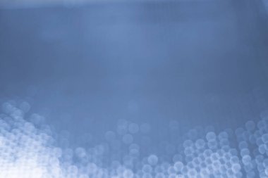 Abstract background with bokeh effect. Blurred defocused lights in blue colors. The bokeh on the background blurred the natural blue and white. Bokeh colorful glows sparkle beautiful. New year day