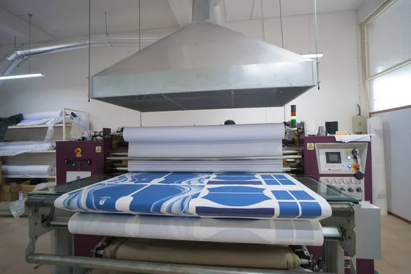 Ba Ria, VIETNAM - OCT 20, 2022 : Interior factory Large heat press machine for fabric business in printing room with Ventilation system. The concept of industrial equipment and technologies