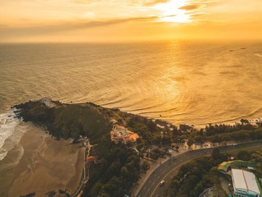 Nghinh Phong cape in Vung Tau, Vietnam. View from above with waves and beautiful cinematic sunset sky.