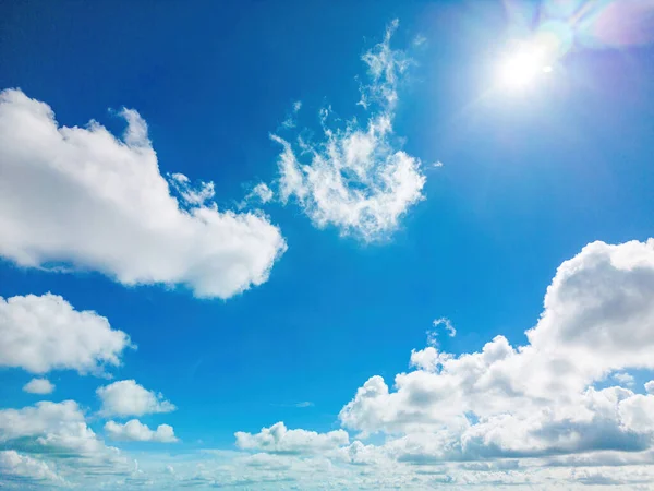 Background cloud summer. Cloud summer. Sky cloud clear. Natural sky beautiful blue and white texture background with sun rays shine. Scenic orange sunset sky background. digital lens flare