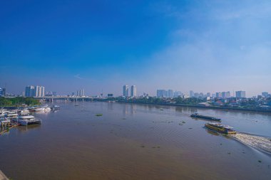 View of Saigon water-bus on the Saigon river and center of Ho Chi Minh city in background