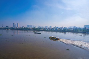 View of Saigon water-bus on the Saigon river and center of Ho Chi Minh city in background