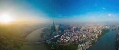 Ho Chi Minh city, Vietnam - DEC 10 2022: Aerial sunset view at Landmark 81 - it is a super tall skyscraper and Saigon bridge with development buildings along Saigon river, cityscape in the night