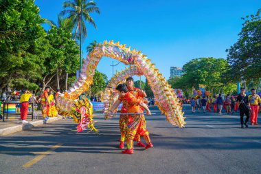 Vung Tau, VIETNAM - JAN 1 2023: Lion and dragon dance perform celebration new year. Group of people perform a traditional lion dance and dragon dance.