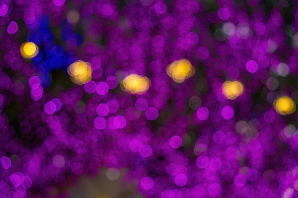 Abstract background of city street in bokeh. Blur focused urban abstract texture bokeh city lights. Design background Celebration. Purple bokeh.