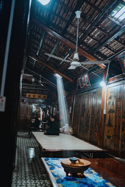 Rays of light coming from a window in an old country Long Son house. Heavenly light in a dusky old house. Palace interior with an old majestic hall, sun rays through the windows