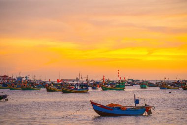 Beautiful cloudscape over the sea, sunrise shot. Lonely boats. Calm sea with sunset sky and sun through the clouds over. Calm sea with sunset sky or sunrise and sun through the clouds over.