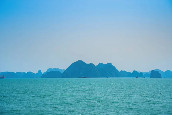 stock image Scenic view of rock island in HaLong Bay, Vietnam, Southeast Asia. UNESCO World Heritage Site. Mountain islands at Ha Long Bay. Beautiful landscape Popular asian landmark famous destination of Vietnam