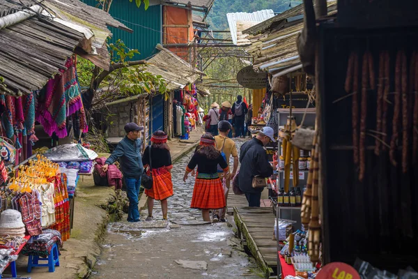 stock image Lao Cai, Vietnam- MAR 12 2023: Beautiful scenery of Cat Cat village,a highland cultural village in Sapa. Street in Cat Cat Hmong village by Sapa with market full of traditional colorful clothes