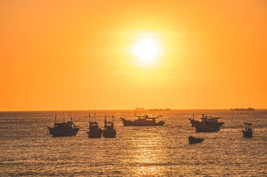 Beautiful cloudscape over the sea, sunrise shot. Lonely boats. Calm sea with sunset sky and sun through the clouds over. Calm sea with sunset sky or sunrise and sun through the clouds over.