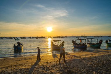 Beautiful cloudscape over the sea, sunrise shot. Lonely boats. Calm sea with sunset sky and sun through the clouds over. Calm sea with sunset sky or sunrise and sun through the clouds over.