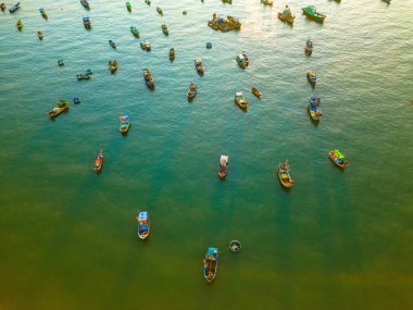 Beautiful cloudscape over the sea, sunrise shot. Lonely boats. Calm sea with sunset sky and sun through the clouds over. Calm sea with sunset sky or sunrise and sun through the clouds over.