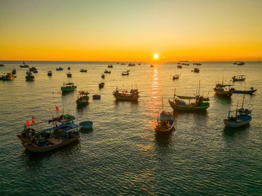 Beautiful cloudscape over the sea, sunrise shot. Lonely boats. Calm sea with sunset sky and sun through the clouds over. Calm sea with sunset sky or sunrise and sun through the clouds over.