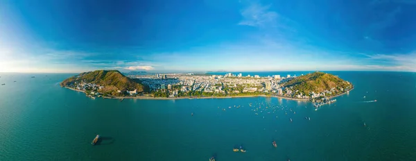 stock image Vung Tau city aerial view with beautiful sunset and so many boats. Panoramic coastal Vung Tau view from above, with waves, coastline, streets, coconut trees and Tao Phung mountain in Vietnam.