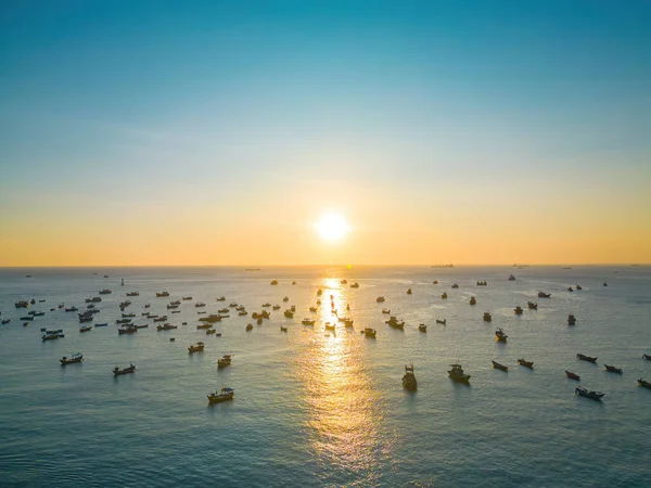 Beautiful cloudscape over the sea, sunrise shot. Lonely boats. Calm sea with sunset sky and sun through the clouds over. Calm sea with sunset sky or sunrise and sun through the clouds over.