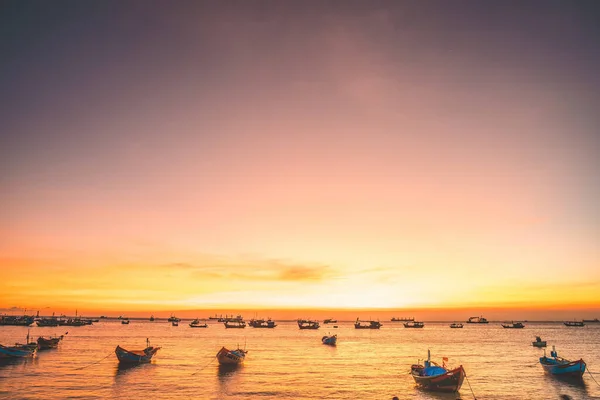 stock image Beautiful cloudscape over the sea, sunrise shot. Lonely boats. Calm sea with sunset sky and sun through the clouds over. Calm sea with sunset sky or sunrise and sun through the clouds over.