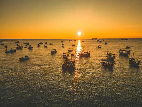 Beautiful cloudscape over the sea, sunrise shot. Lonely boats. Calm sea with sunset sky and sun through the clouds over. Calm sea with sunset sky or sunrise and sun through the clouds over.