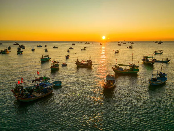 Beautiful cloudscape over the sea, sunrise shot. Lonely boats. Calm sea with sunset sky and sun through the clouds over. Calm sea with sunset sky or sunrise and sun through the clouds over.