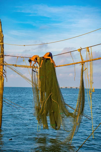 https://st5.depositphotos.com/76344838/65066/i/450/depositphotos_650664246-stock-photo-two-fishermen-casting-nets-fishing.jpg