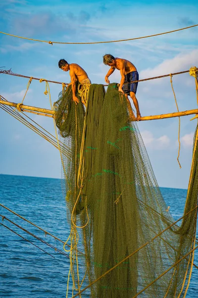https://st5.depositphotos.com/76344838/65066/i/450/depositphotos_650664570-stock-photo-two-fishermen-casting-nets-fishing.jpg