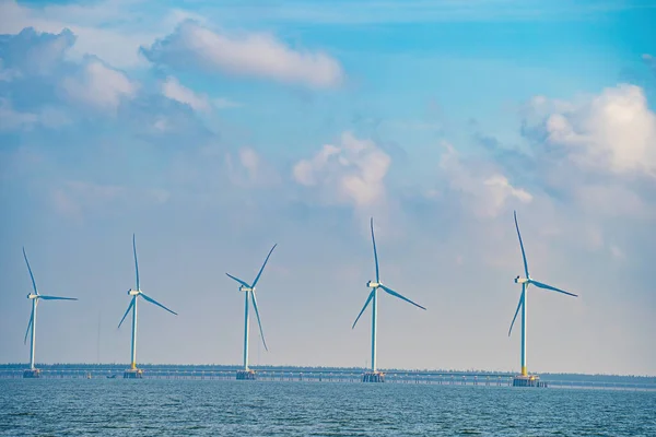 stock image Panoramic view of wind farm at sea, with high wind turbines for generation electricity with copy space at Tra Vinh, Viet Nam. Green energy concept. Eco concpept