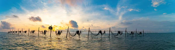 Top view fishermen casting a nets on fishing poles on beautiful sunrise. Traditional fishermen prepare the fishing net, local people call it is Day hang khoi. Fisheries and everyday life concept.