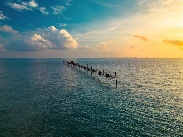 stock image Top view fishermen casting a nets on fishing poles on beautiful sunrise. Traditional fishermen prepare the fishing net, local people call it is Day hang khoi. Fisheries and everyday life concept.