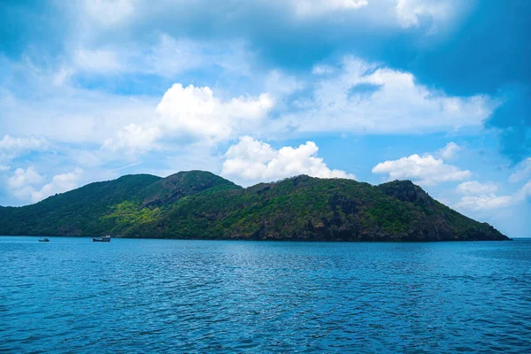 stock image Panoramic coastal Con Dao island view from above, with waves, coastline ,clear sky and road, blue sea and mountain.