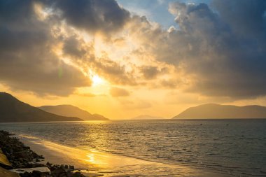 Calm sea with sunset sky and sun through the clouds over. Calm sea with sunset sky and sun through the clouds over. Meditation ocean and sky background. Tranquil seascape. Horizon over the water.