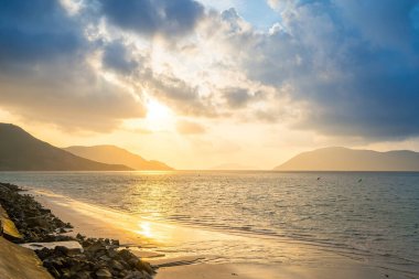 Calm sea with sunset sky and sun through the clouds over. Calm sea with sunset sky and sun through the clouds over. Meditation ocean and sky background. Tranquil seascape. Horizon over the water.