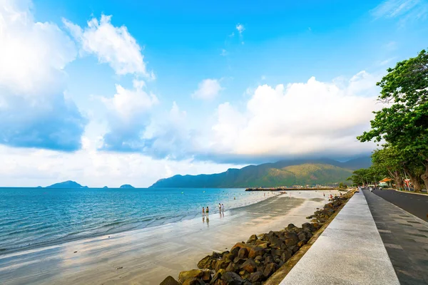 stock image Panoramic coastal Con Dao island view from above, with waves, coastline ,clear sky and road, blue sea and mountain.