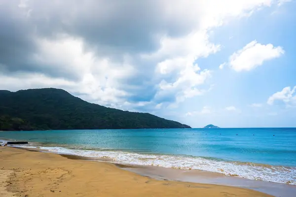 stock image Beautiful Dam Trau beach in Con Dao island. Bottom view Airplane is landing. Wild beach Con Dao island from above with blue sea and mountain, so many cloud.