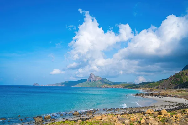 stock image Panoramic coastal Con Dao island view from above, with waves, coastline ,clear sky and road, blue sea and mountain. Aerial view of Bai Nhat beach with cloudy day. Travel concept