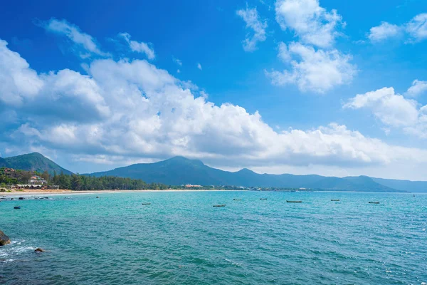 stock image Panoramic coastal Con Dao island view from above, with waves, coastline ,clear sky and road, blue sea and mountain. Aerial view of Bai Nhat beach with cloudy day. Travel concept