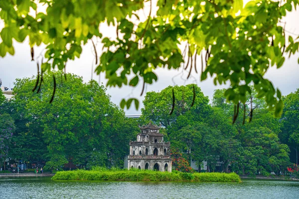 stock image Blurred background Hoan Kiem Lake ( Ho Guom) or Sword lake in the center of Hanoi in the fog in the morning. Hoan Kiem Lake is a famous tourist place in Hanoi. Travel and landscape concept.