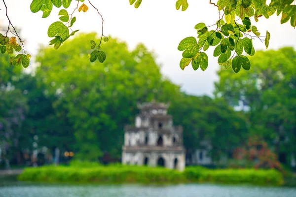 stock image Blurred background Hoan Kiem Lake ( Ho Guom) or Sword lake in the center of Hanoi in the fog in the morning. Hoan Kiem Lake is a famous tourist place in Hanoi. Travel and landscape concept.