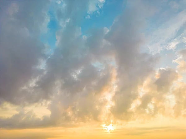 Beautiful view of blue sky with clouds at sunrise. Partly cloudy.Background cloud summer. Cloud summer. Sky cloud clear with sunset. Natural sky cinematic beautiful yellow and white texture background
