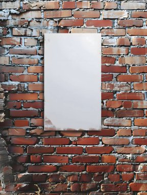 Bir şehir binasının tuğla duvarında beyaz boş bir poster